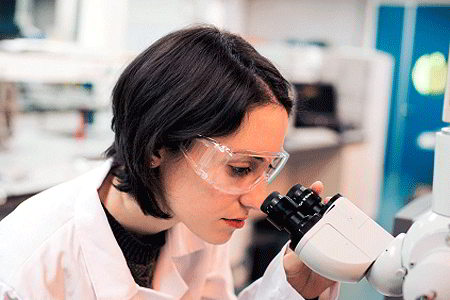 Women looking through microscope (iStockphoto)