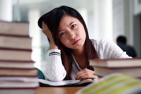 Woman struggling to study (iStockphoto)
