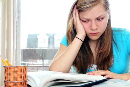 Stressed-out girl studying at home