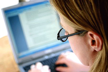Woman working on laptop (iStockphoto)