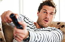 Young man playing video game (iStockphoto)
